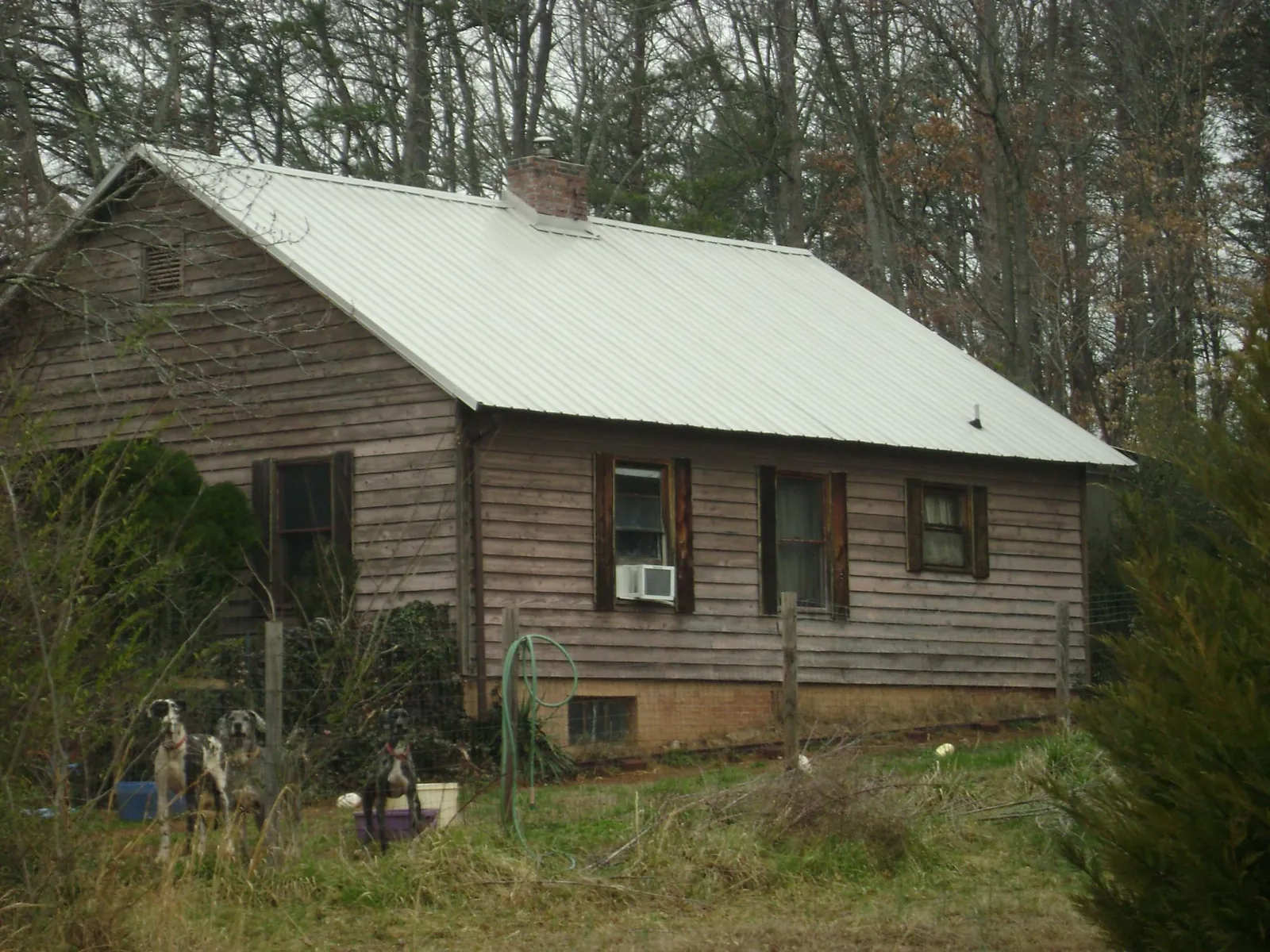 White metal roof on an old wood sided farmhouse, from a Metal Roof Installation job in Middleburg